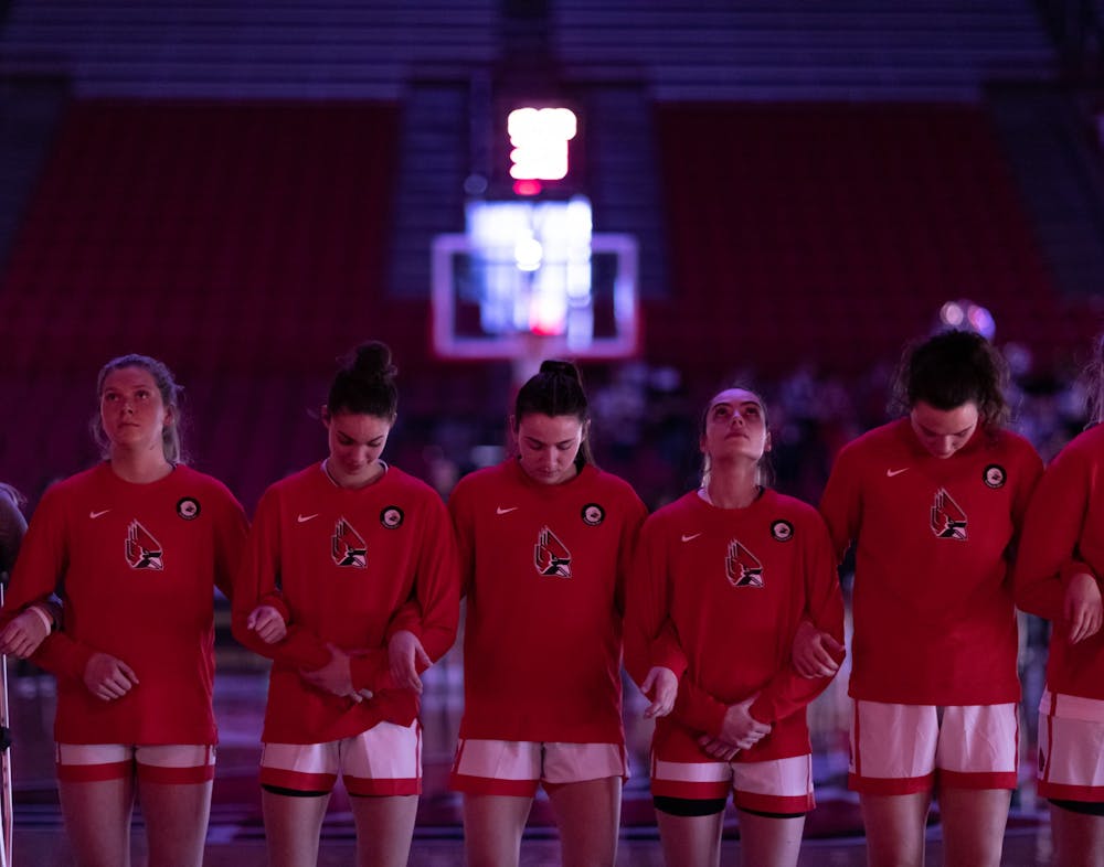 Members of the Ball State Women's Basketball team stand with their arms interlocked before their game against Eastern Michigan University Mar. 5 at Worthen Arena. The Cardinals stong offense led them to a 92-58 victory over Eastern Michigan. Eli Houser, DN