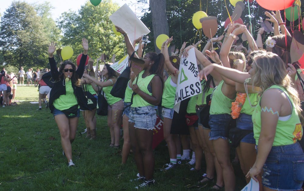Leighnee Smith, a junior speech pathology major, blows a whistle to rally Alpha Gamma Delta before the new members arrive at Bid Day on Sept. 8 at the Quad. DN PHOTO BREANNA DAUGHERTY 
