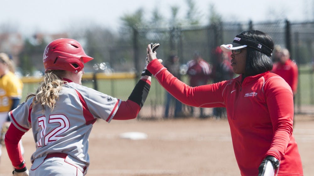 Senior Lauren Schroeder high-fives head coach Tyra Perry after her home run against Toledo on April 5. DN PHOTO JONATHAN MIKSANEK