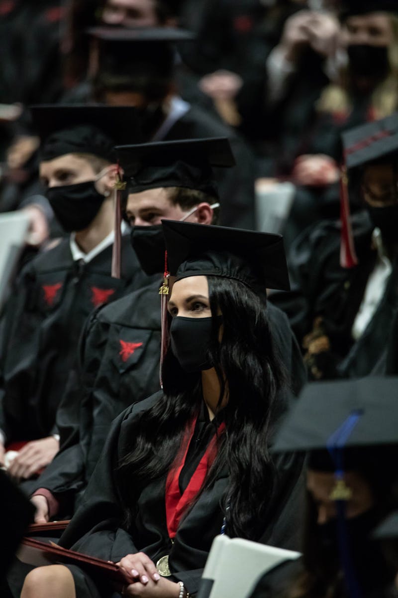 Graduates listen to Provost Susana Rivera-Mills speak during the graduation ceremony Dec. 18 at Worthen Arena. The graduation was split into two separate ceremonies, the first of which started at 10 a.m. Eli Houser, DN