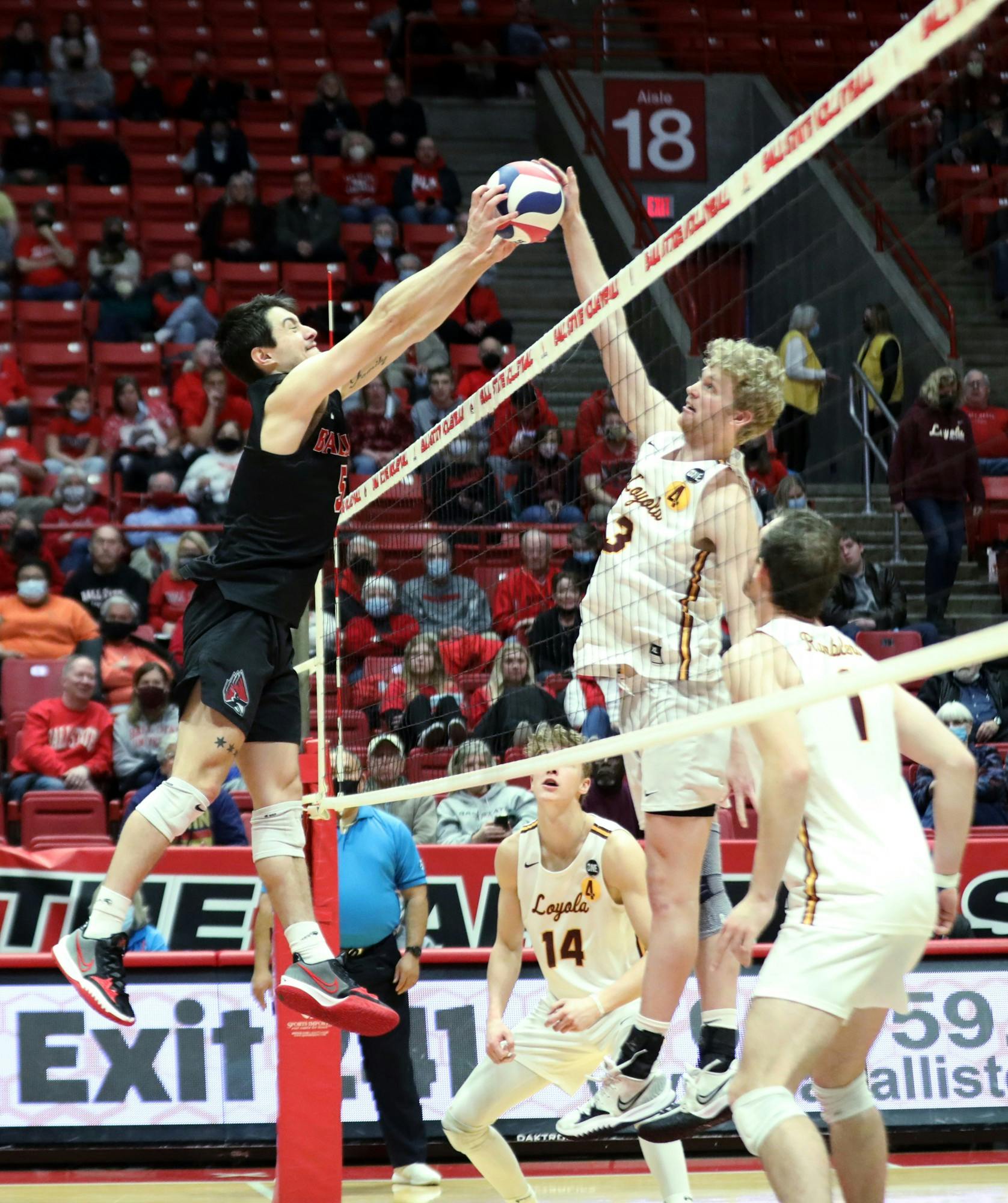Graduate student setter Quinn Isaacson blocks the ball in a game against Loyola Chicago Feb. 19 at Worthen Arena. Isaacson had three blocks during the game. Amber Pietz, DN