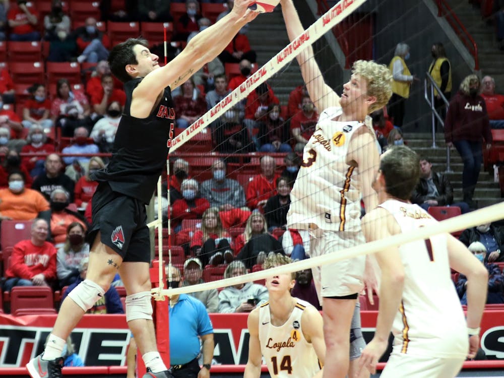 Graduate student setter Quinn Isaacson blocks the ball in a game against Loyola Chicago Feb. 19 at Worthen Arena. Isaacson had three blocks during the game. Amber Pietz, DN