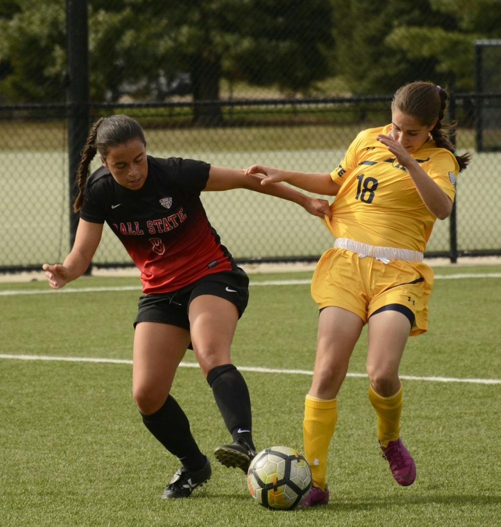 Ball State junior midfielder Paula Guerrero fights for the ball with Kent states freshman midfielder Vital Kats on Oct. 1 at Briner Sports Complex. The Cardinals won 1-0. Harrison Raft, DN