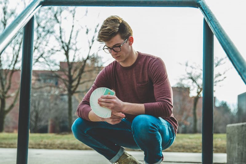 Junior telecommunications major Nate Lex does cardistry with the Peelers deck of Organic Playing Cards in 2018. Lex began cardistry in 2013 as a way to channel his energy because he said he has ADHD and has always been fidgety. Cameron Toner, Photo Provided. 