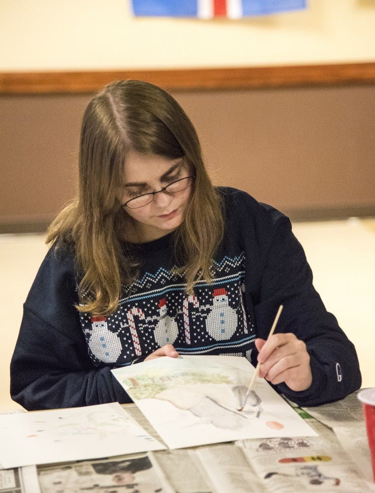 Junior Heather Nunn water paints a picture of a mountainous setting. The Asian American Student Association held the water painting event as part of their month of events. DN PHOTO RACHEL BRAMMER