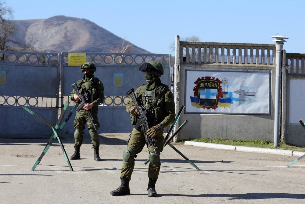 Russian soldiers stand guard next to a Ukrainian military base in the town of Bakhchysarai in the Crimea. MCT PHOTO