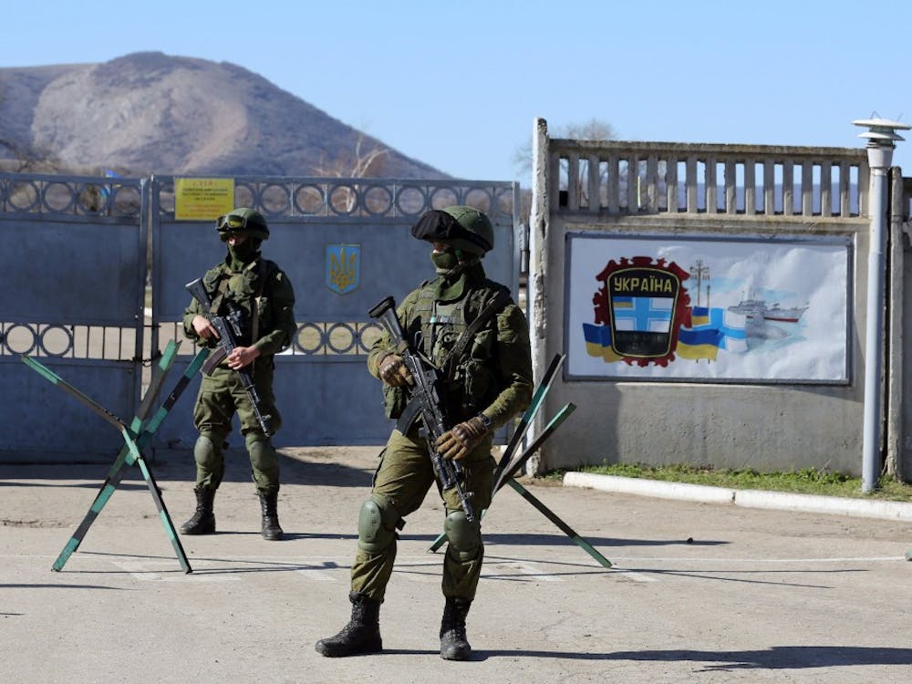 Russian soldiers stand guard next to a Ukrainian military base in the town of Bakhchysarai in the Crimea. MCT PHOTO