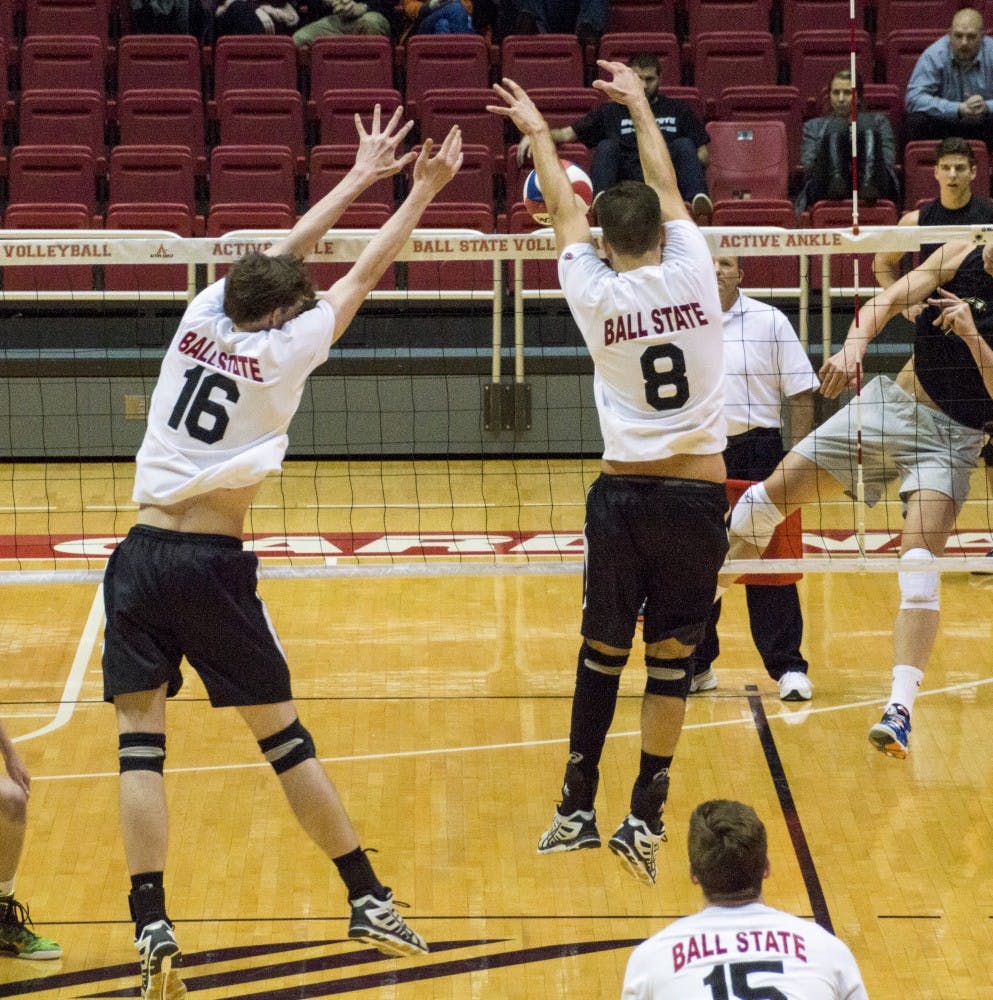 Freshman middle attacker Matt Walsh and junior setter Hiago Garchet jump to block the ball during the game against George Mason on Feb. 7 at Worthen Arena. DN PHOTO ALAINA JAYE HALSEY