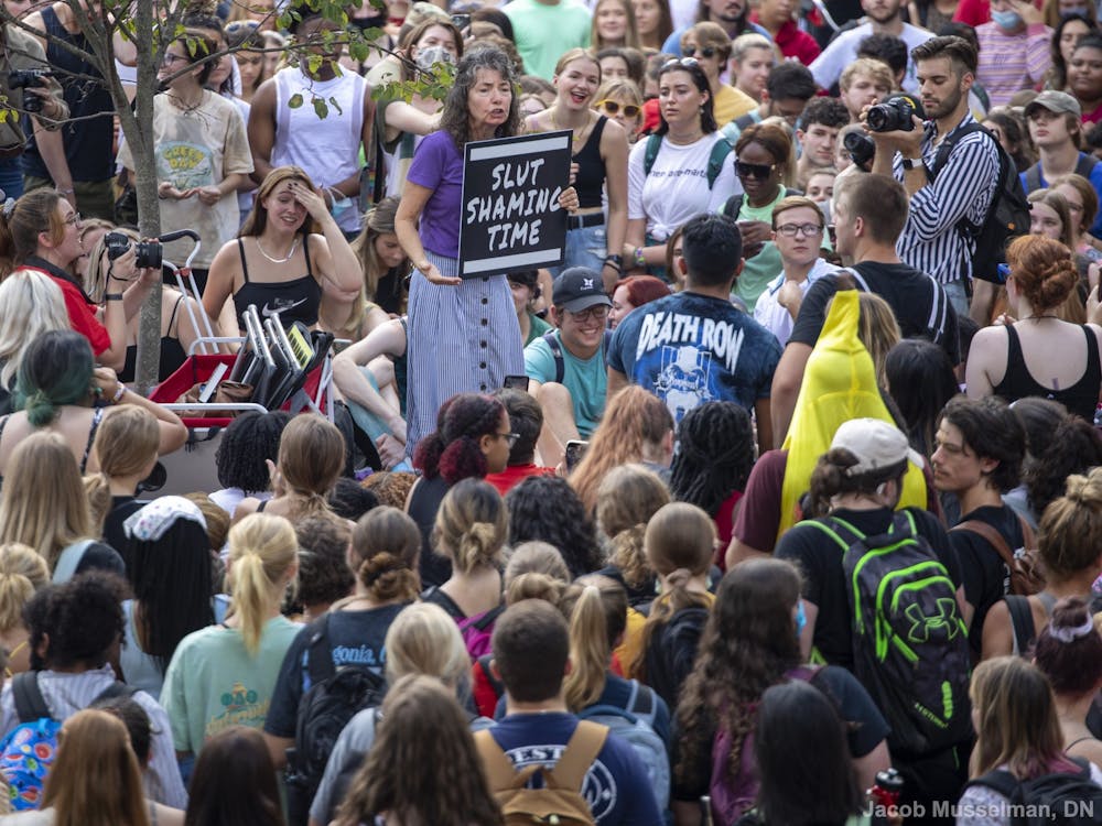 “Sister Cindy” Smock speaks to a crowd of students at her “Ho no mo” rally Sept. 17, 2021, at the Quad. Smock and her husband, “Brother Jed,” travel the country going to different colleges and preaching their beliefs. Jacob Musselman, DN