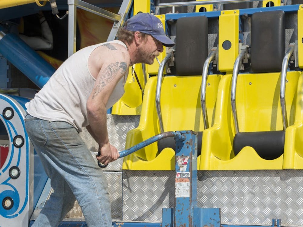 David Carmichael, a Poor Jack Amusement employee, works on the 1,001 Nachts Ride that will be at the Late Nite Carnival. Late Nite will feature a balloon artist, caricature and cotton candy. DN PHOTO TAYLOR IRBY