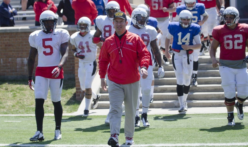 Head coach Pete Lembo walks out with the football team before playing the spring football game on April 19 at Scheumann Stadium. DN PHOTO BREANNA DAUGHERTY 