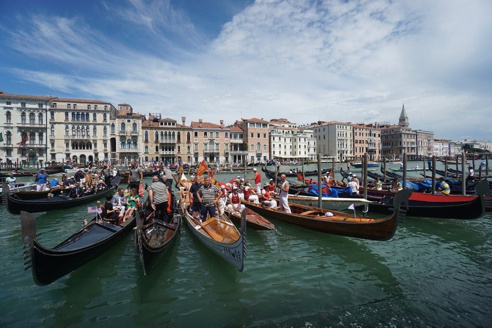 Gondolas are lined up during the Vogada della Rinascita regatta, June 21, 2020, along Venice canals, Italy. European Union envoys are close to finalizing a list of countries whose citizens will be allowed back into Europe once it begins lifting coronavirus-linked restrictions. (Anteo Marinoni/LaPresse via AP, File)