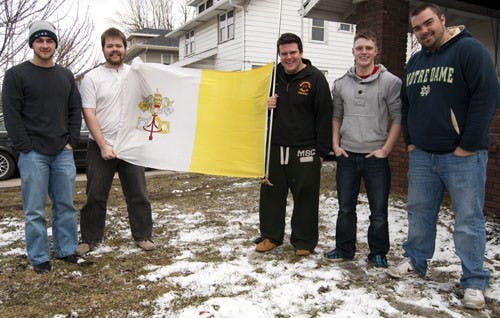 Jacob Dungan, Ben Cramer, Andrew Thornton, Chris Beck and Kyle Garretson display the flag of the Vatican. Cramer and Garretson brought the flag to Dungan