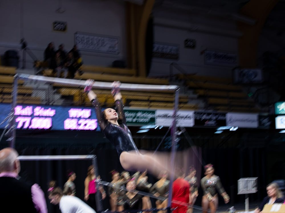 A Western Michigan gymnast performs her uneven parallel bar routine against Ball State Feb. 9, 2020, at Read Fieldhouse in Kalamazoo, Michigan. The Broncos beat the Cardinals 195.750-193.675. Jacob Musselman, DN