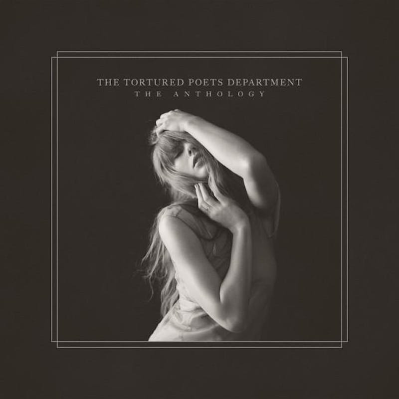 Taylor Swift poses dramatically against a dark background, showcasing the title "The Tortured Poets Department: The Anthology"
