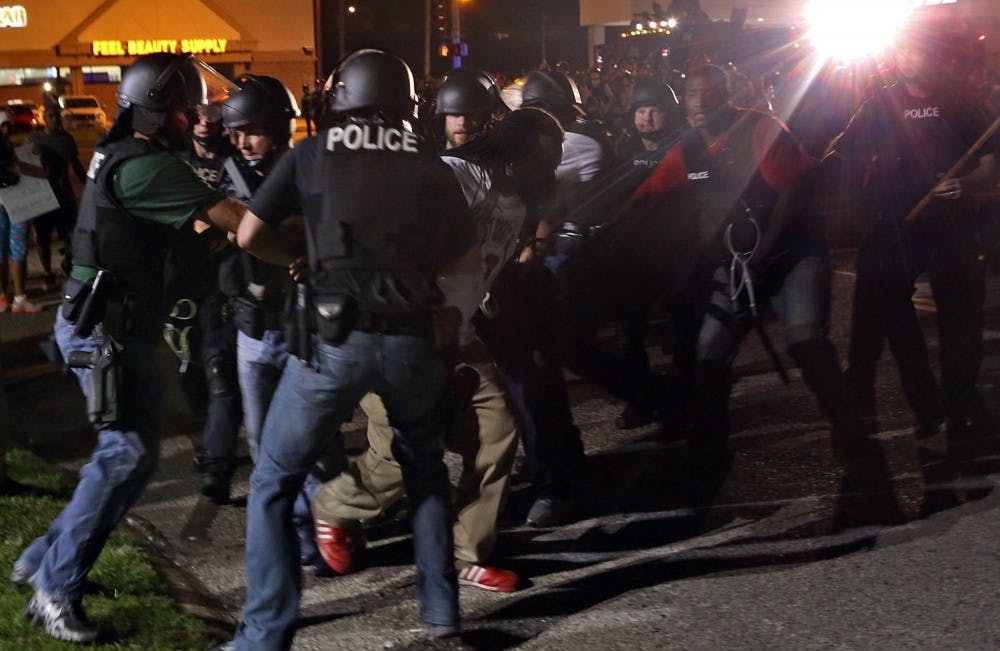Police rushed a protester who was taunting and cursing them on W. Florissant in Ferguson, Mo. on Monday night, Aug. 18, 2014, next to the media area at Ferguson and W. Florissant. (J.B. Forbes/St. Louis Post-Dispatch/MCT)