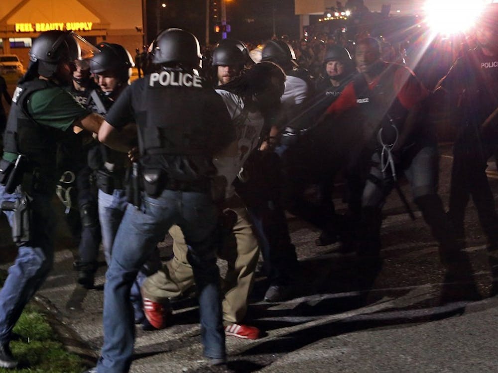 Police rushed a protester who was taunting and cursing them on W. Florissant in Ferguson, Mo. on Monday night, Aug. 18, 2014, next to the media area at Ferguson and W. Florissant. (J.B. Forbes/St. Louis Post-Dispatch/MCT)