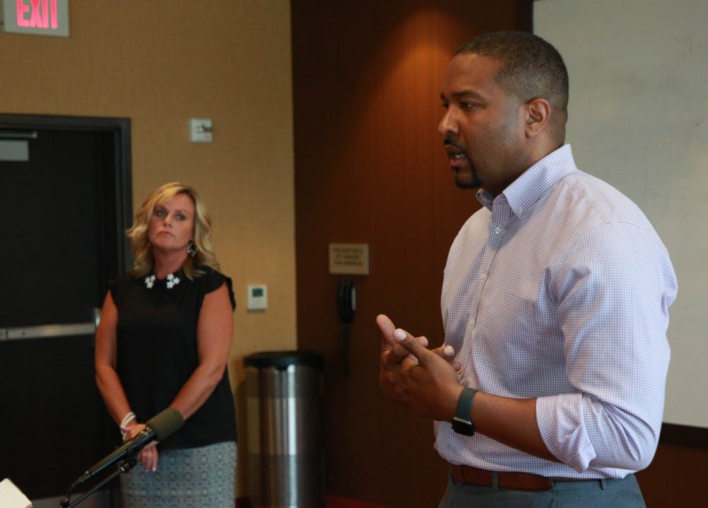 Sen. Eddie Melton (D-Gary) speaks to people gathered Aug. 15, 2019, at a Courtyard by Marriott hotel conference room as Jennifer McCormick, superintendent of public instruction, looks on. The discussion was part of their statewide tour called Hoosier Community Conversations focused on public education. Rohith Rao, DN