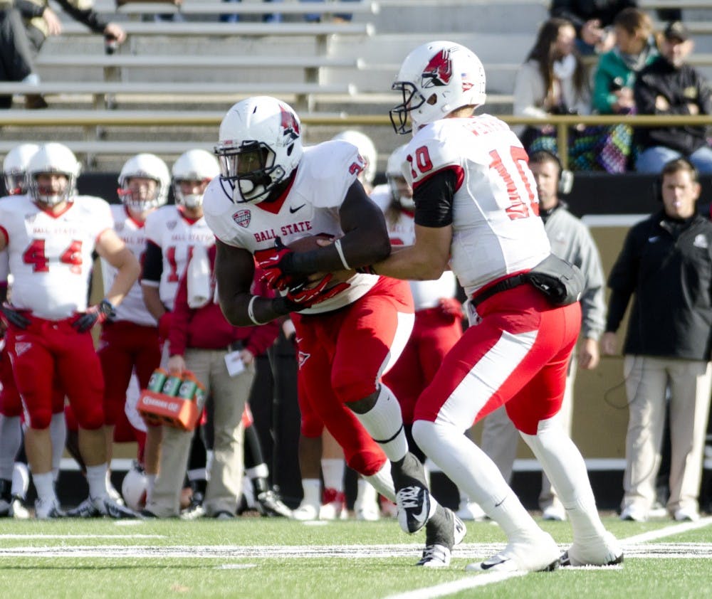 	Junior running back Jahwan Edwards takes a handoff from senior quarterback Keith Wenning at Waldo Stadium against Western Michigan University on Oct. 19. Edwards finished with 92 yards rushing and one touchdown.
