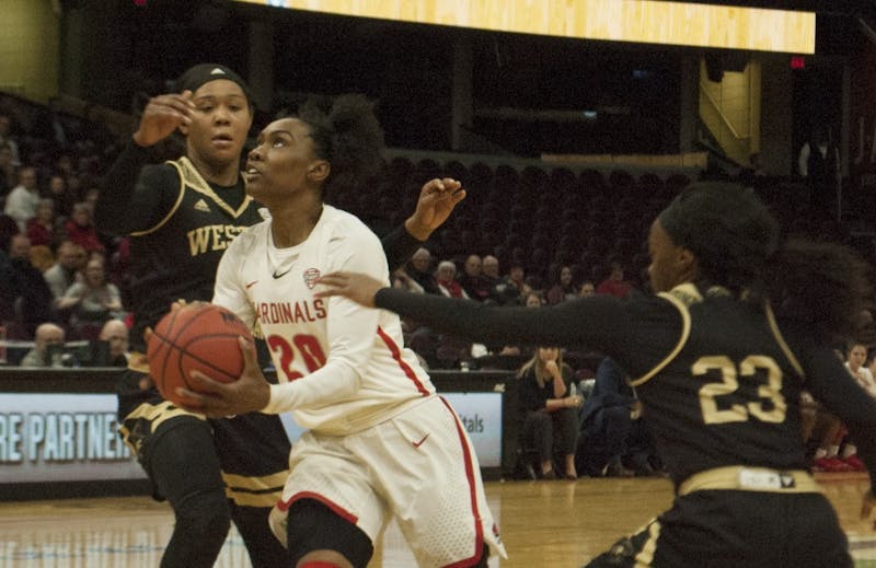 Ball State senior guard Frannie Frazier dribbles through a pair of Western Michigan defenders during the quarterfinal round of the Mid-American Conference Tournament. Robby General, DN