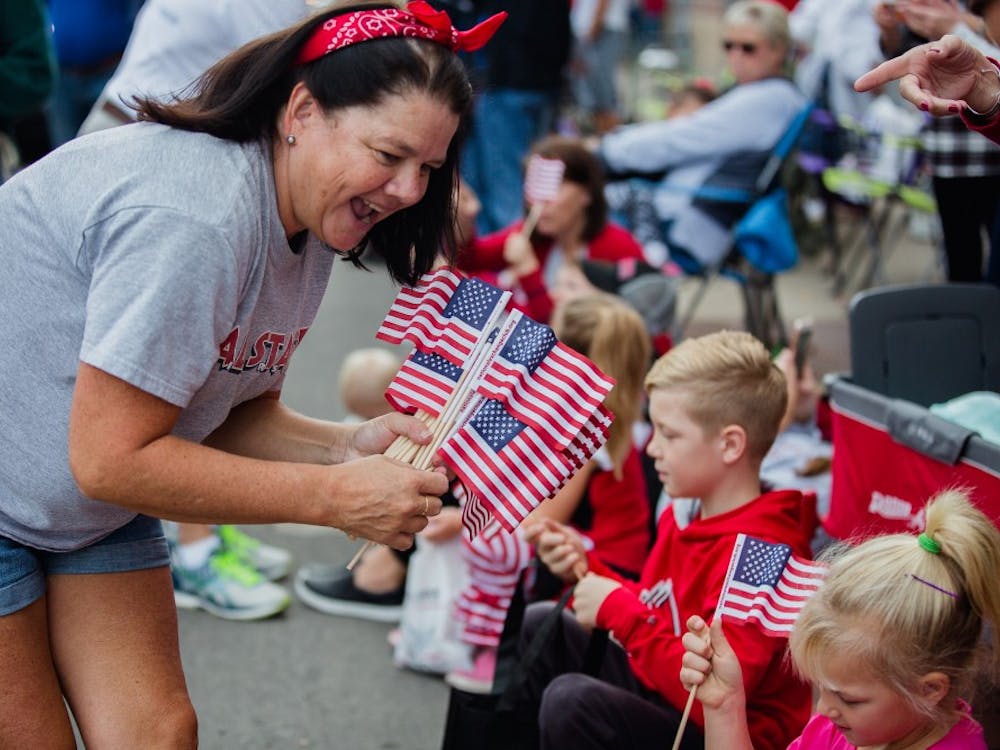 Small American flags were given out to parade goers at Ball State's Homecoming parade Oct. 21, 2017. The parade this year will be limited to 100 floats and will commemorate the university's centennial Oct. 20, 2018. Reagan Allen, DN