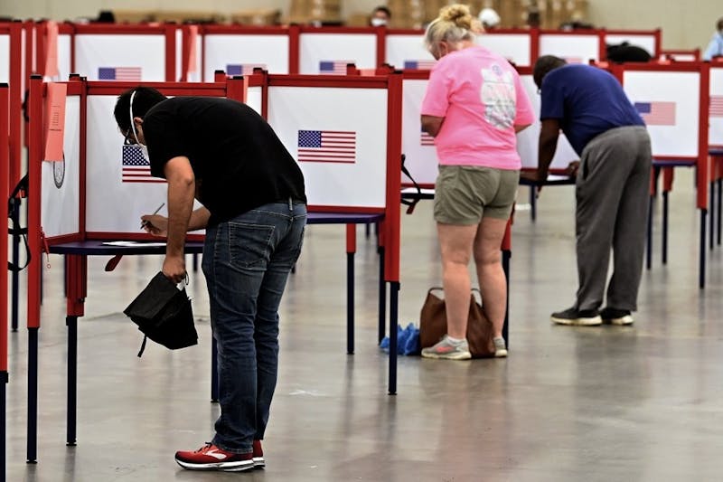 Voters fill out their ballots during in person voting in the Kentucky Primary at the Kentucky Exposition Center June 23, 2020, in Louisville, Ky. In an attempt to prevent the spread of the coronavirus, voters that didn't cast mail in ballots were directed to one central polling location. (AP Photo/Timothy D. Easley)