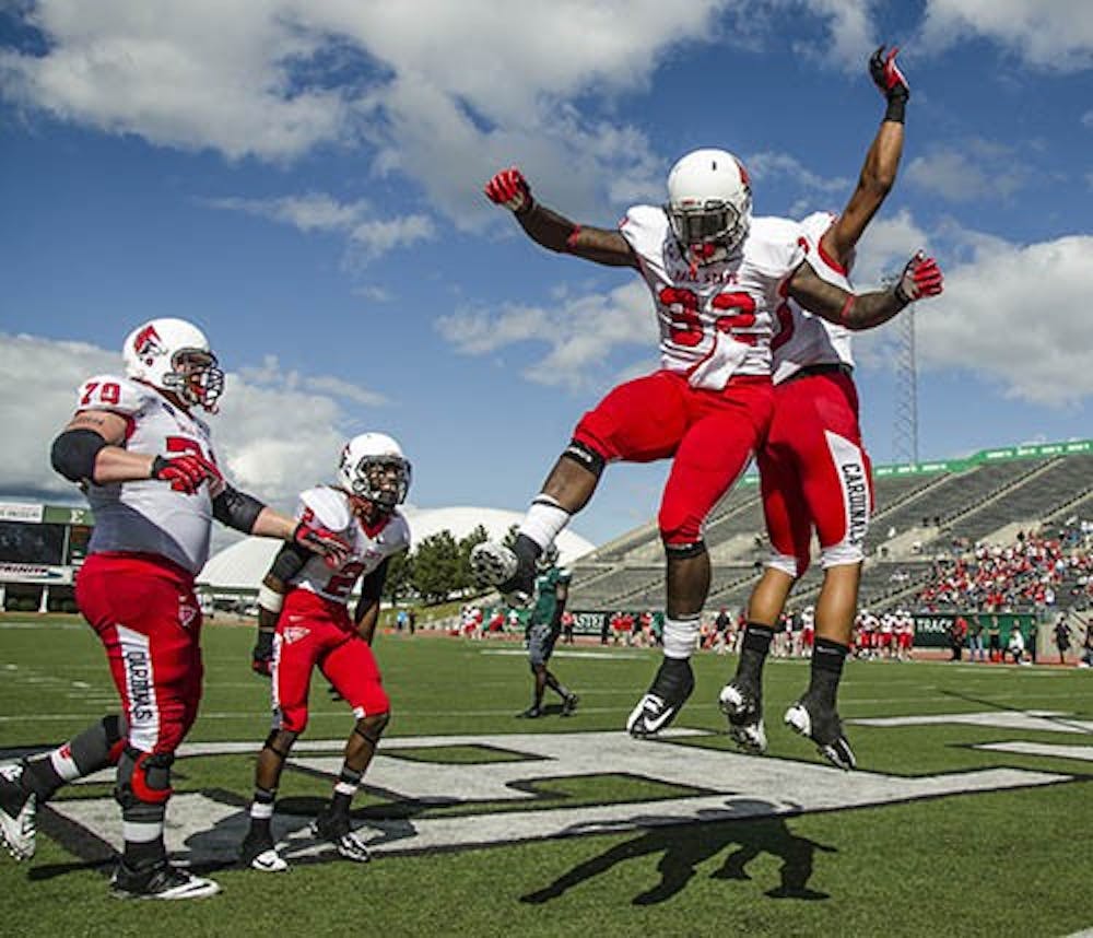 Jahwan Edwards celebrates with his teammates after a touchdown at Ball State's away game at Eastern Michigan University. Ball State would win 51-20 by the end of the game. DN PHOTO COREY OHLENKAMP
