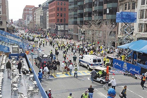 Emergency personnel assist the victims at the scene of a bomb blast during the Boston Marathon on Monday. MCT PHOTO