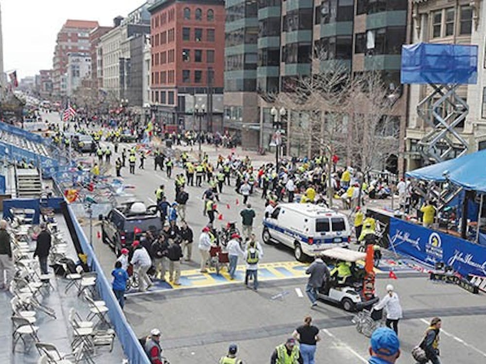 Emergency personnel assist the victims at the scene of a bomb blast during the Boston Marathon on Monday. MCT PHOTO