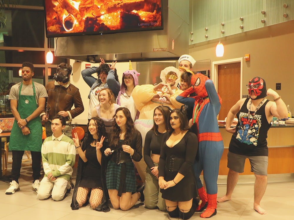 Ball State students dressed in Halloween costumes pose for a group photo in Botsford/Swinford residence hall Oct. 27. The president and council of Botsford/Swinford planned a movie and "Scaryoke" activity for their residents. (Maya Kim, DN)