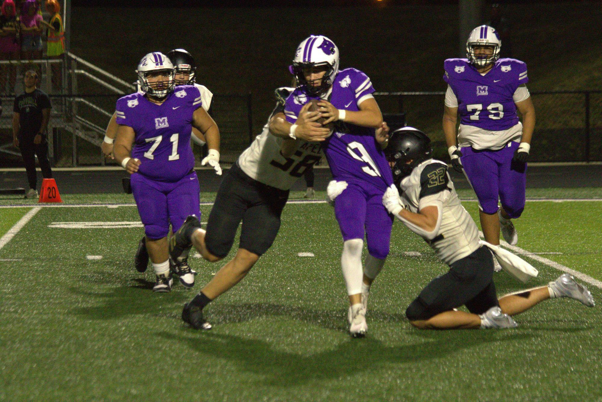 Lapel’s #22 Mason Kenemer and #58 Will Gilbert both working to bring down Muncie Central quarterback #9 Alakai Wallace. Lapel will look to retain their top-10 state standing in 2A against the Indian Creek Braves next Friday night. PHOTO BY CHRIS MCCALLA. 
