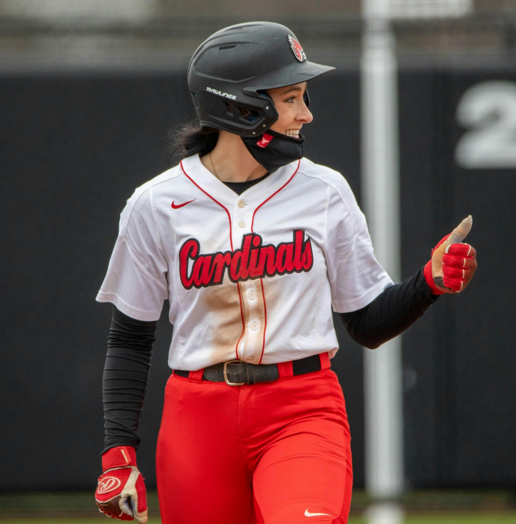Junior outfielder Faith Hensley gives senior outfielder Kennedy Wynn a thumbs up after Wynn's double hitter March 26, 2021, at the Softball Field at First Merchants Ballpark Complex. The Cardinals won 8-6 against the Falcons. Jaden Whiteman, DN