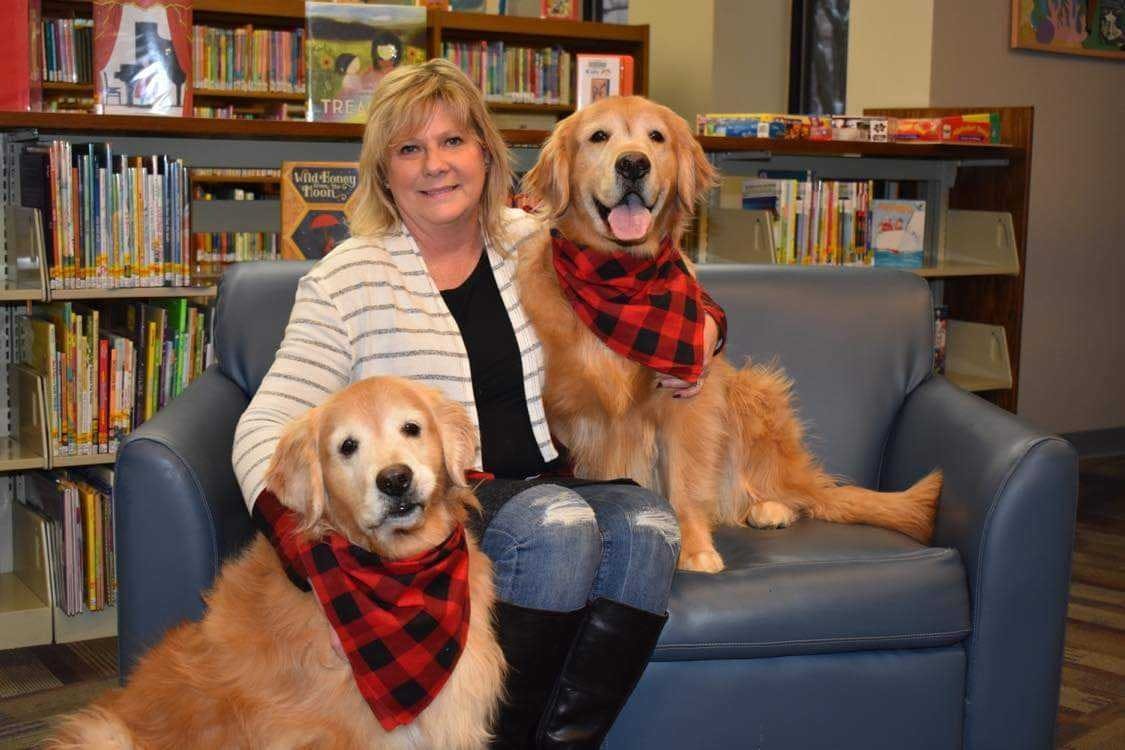 Cindie Hudson sits with her therapy dogs, Harlee and Seger, at the Kokomo-Howard County Public Library. Hudson recently published a children&#x27;s book called &quot;Yellow Dog&quot; in an effort to encourage children to read. Cindie Hudson, Photo Provided