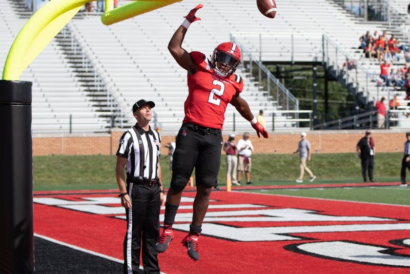 Junior running back Caleb Huntley dunks the ball on the goal post after scoring a touchdown against Fordham Sept. 7, 2019, at Scheumann Stadium. Huntley averaged 4.9 yards per carry during the game. Jacob Musselman, DN