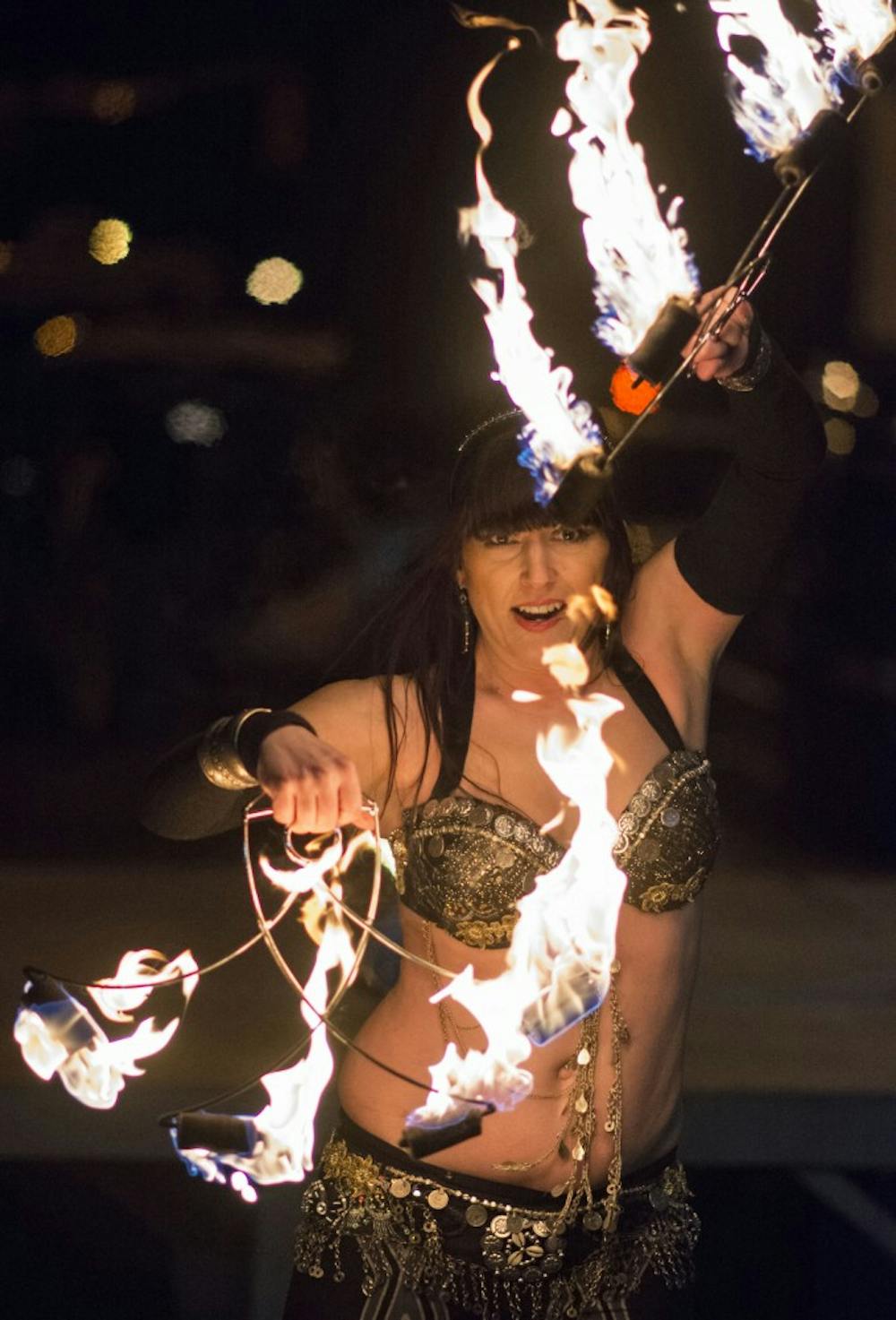 A belly dancer performs her fire artistry Saturday at the Muncie Gras event in downtown Muncie. DN PHOTO SAMANTHA BLANKENSHIP