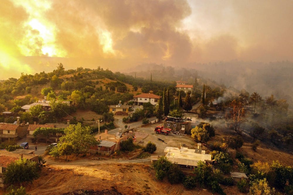 This aerial photograph shows houses surrounded by a wildfire which engulfed a Mediterranean resort region on Turkey's southern coast near the town of Manavgat, on July 30, 2021. (AFP/Getty Images/TNS)