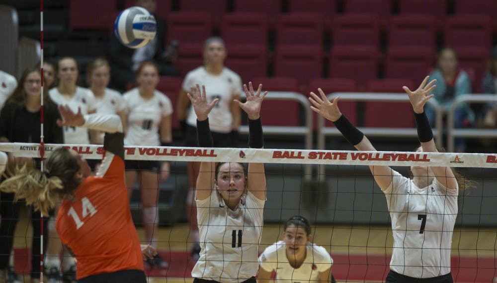 Sophomore setter Amber Seaman and junior middle hitter Emily Holland attempt to block a shot from a Bowling Green player on Oct. 20 at Worthen Arena. Breanna Daugherty, DN File