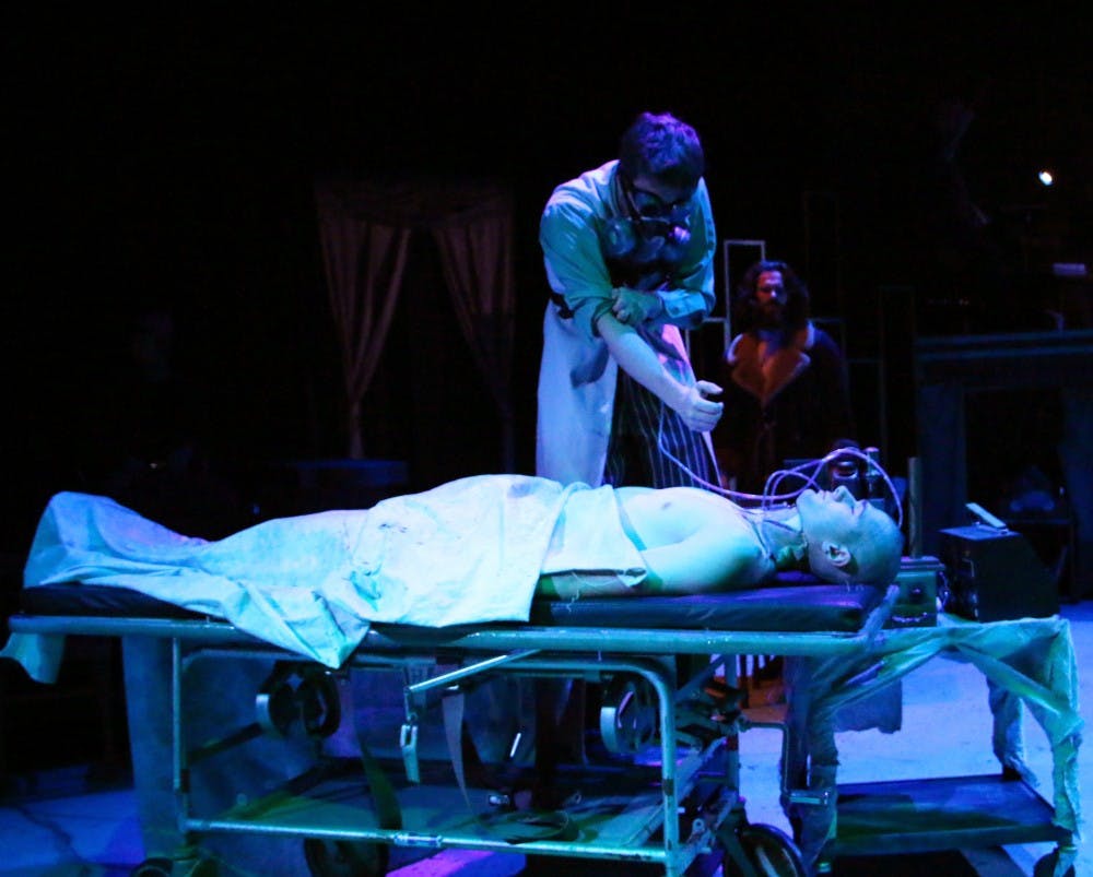 Frankenstein, played by Cole Abell, works on The Creature, played by Nick Murhling, during the final dress rehearsal of 