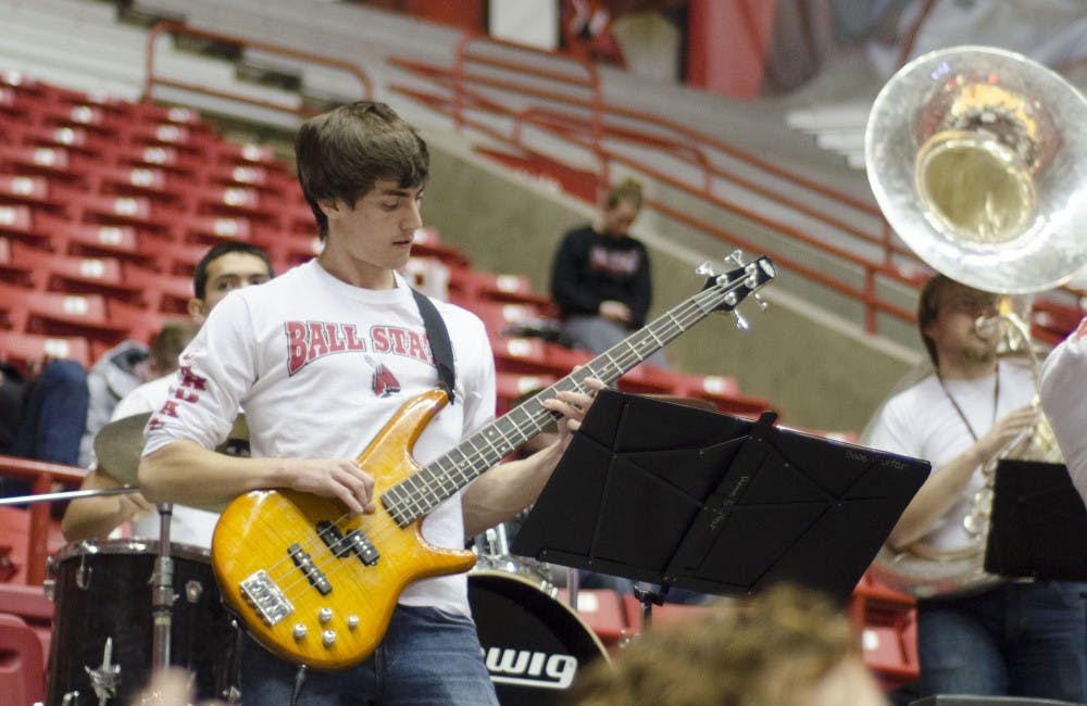 A member of the Ball State pep band plays the bass guitar during the men's basketball game against Western Michigan on Feb. 26 at Worthen Arena. DN PHOTO AUDREY ADDINGTON 