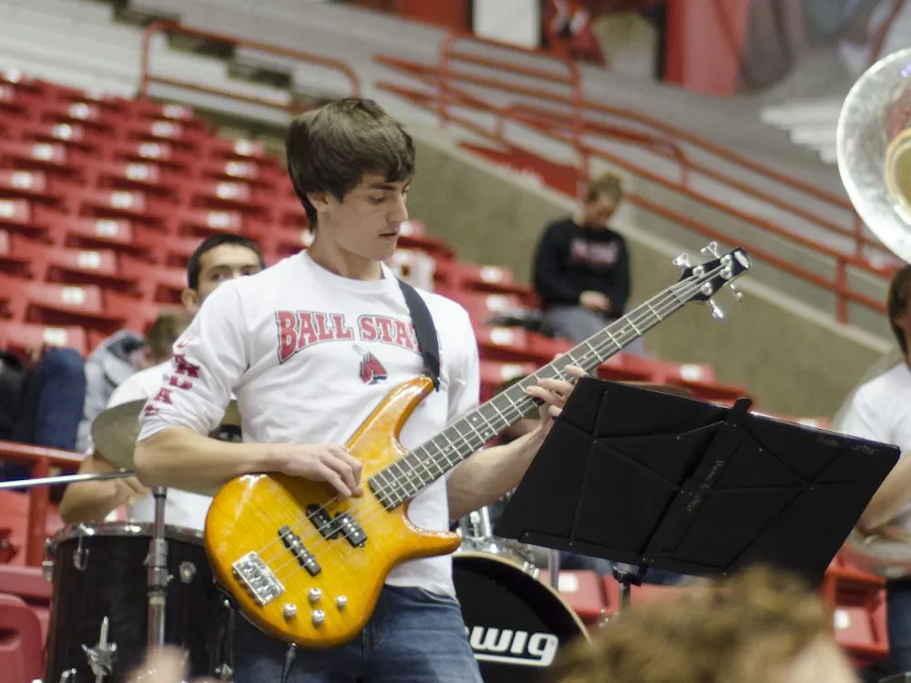 A member of the Ball State pep band plays the bass guitar during the men's basketball game against Western Michigan on Feb. 26 at Worthen Arena. DN PHOTO AUDREY ADDINGTON