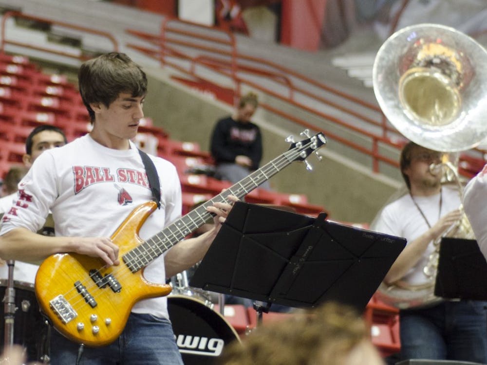 A member of the Ball State pep band plays the bass guitar during the men's basketball game against Western Michigan on Feb. 26 at Worthen Arena. DN PHOTO AUDREY ADDINGTON 