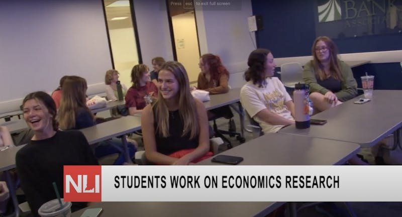 Students meet to discuss economics data