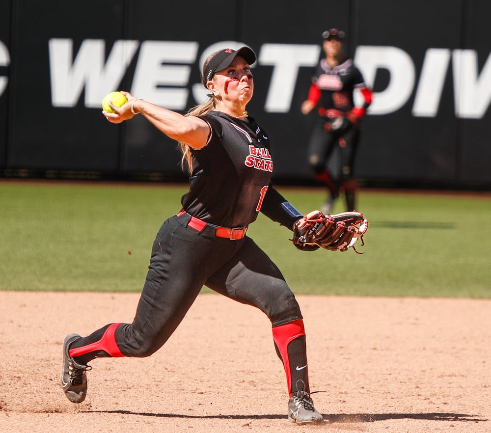 <p>Sophomore utility McKenna Mulholland throws the ball to first after a hit against Bowling Green April 13 at First Merchants Ballpark Complex. Mulholland had three assists in the game. Andrew Berger, DN</p>