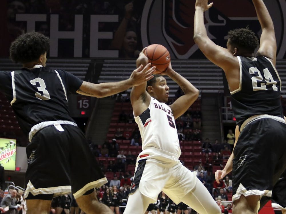 Ball State sophomore guard Ishmael El-Amin tries to find an open teammate while being guarded by the University of Indianapolis' Marcus Latham (3) and Radwan Bakkali (24) during the Cardinals' exhibition game against the Greyhounds Nov. 2, 2018, in John E. Worthen Arena. Ball State won 92-76. Paige Grider, DN