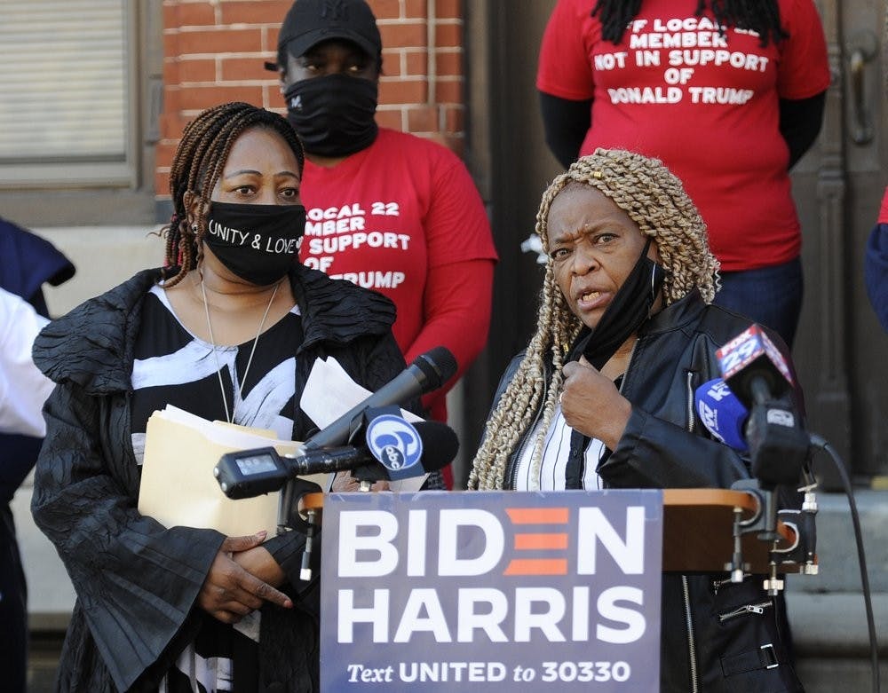 Crystal Williams-Coleman, President the Guardian Civic League, right, talks to reporters during a press conference, Friday, Oct. 9, 2020, in Philadelphia. Public servants, firefighters, paramedics, emergency responders and a diverse group of law enforcement professionals denounced the Fraternal Order of Police and Local 22 for not listening to the concerns of the dues paying union members when endorsing President Donald J. Trump for re-election. (AP Photo/Michael Perez)