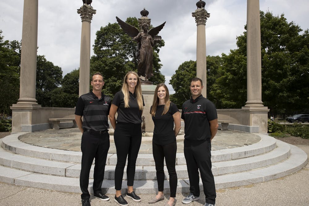 <p>(Left to right) Assistant coach Fritz Rosenberg, assistant coach Tiffany Koors, head coach Kelli Miller Phillips and assistant coach Brad Kline pose in front of Ball State&#x27;s statue of Beneficence. The staff is in their sixth season together. <em><strong>Ball State Athletics, photo provided.</strong></em></p>