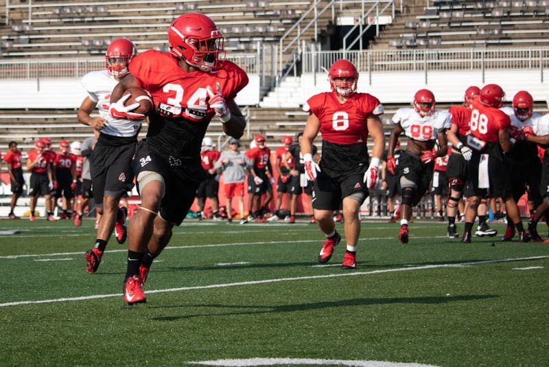 Redshirt junior running back James Gilbert &nbsp;runs the ball up the field during practice Monday, Aug. 27, 2018 at Scheumann Stadium. The team's offense and defense scrimmaged each other at practice. Rebecca Slezak,DN