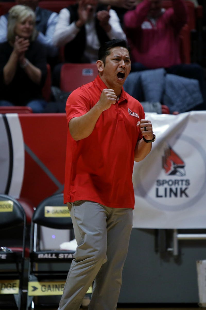 Ball State Men's Volleyball Head Coach Donan Cruz celebrates a point being scored in a game against Ohio St. March 19 at Worthen Arena. The Cardinals beat the Buckeyes 3-1 in the game. Amber Pietz, DN