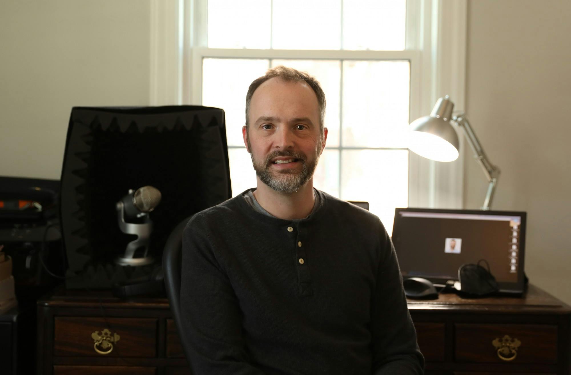 Associate Professor of Spanish Stephen Hessel poses for a photo in his podcast studio Feb. 15 near Jackson Street. Hessel had the idea for &quot;Pod Quixote&quot; during the COVID-19 pandemic and released his first episode Aug. 16, 2021. Rylan Capper, DN