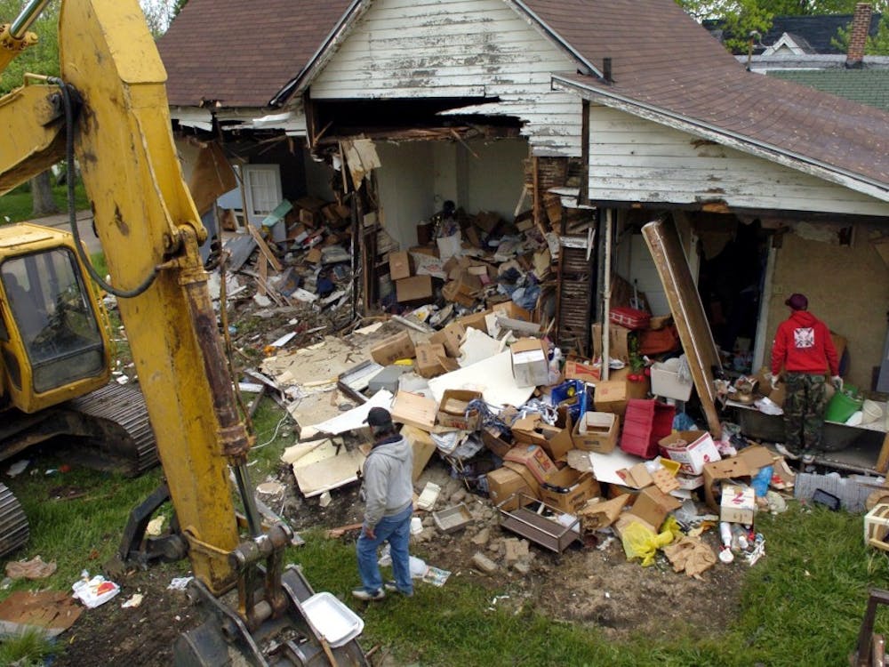 Workers from A&A Backhoe company scavenge for items from an abandoned building slated for demolition in Anderson, Ind. In 2005, the city started bulldozing abandoned houses that had become magnets for drug dealers, thieves and arsonists. MCT PHOTO